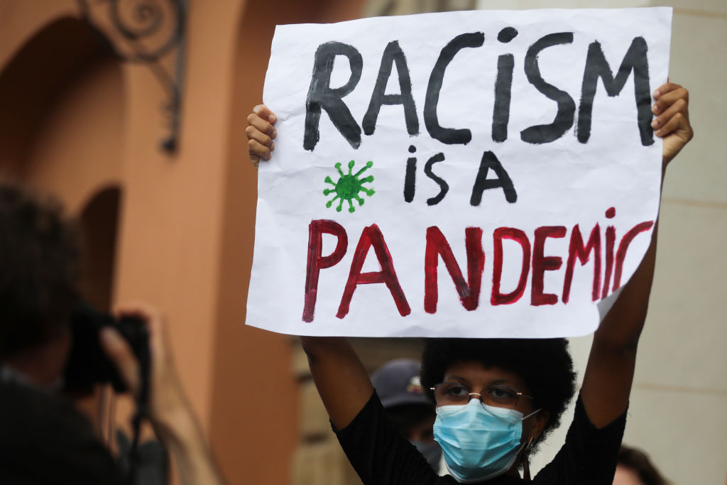 Image of poster stating racism is a pandemic